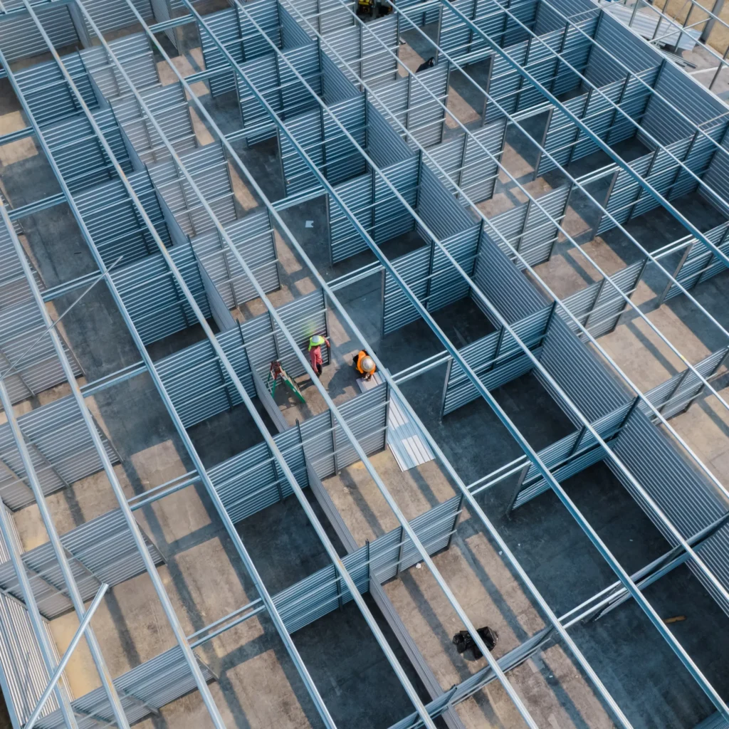 Aerial drone shot of BuiltRite employees installing a single-story storage unit building.